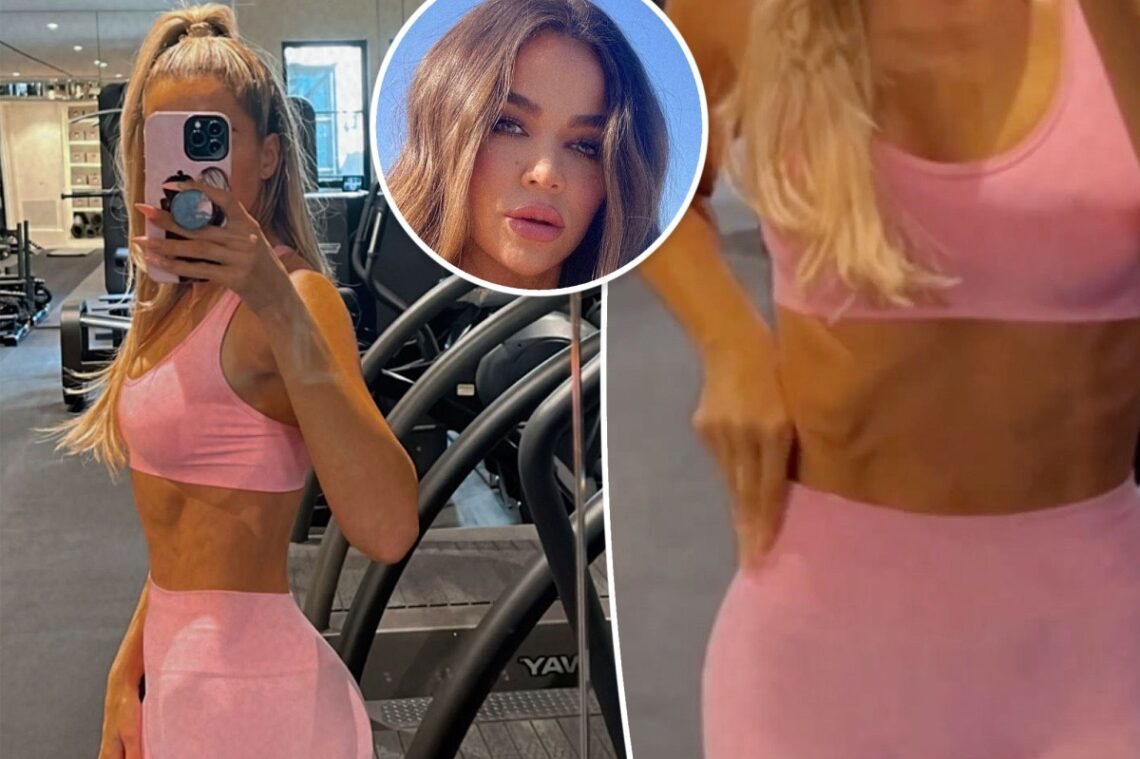 Khloé Kardashian flaunts her abs while working out in matching pink set